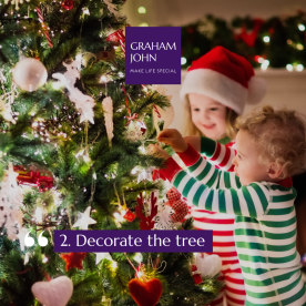 Close-up of festive ornaments and twinkling lights on a Christmas tree, Kent home, evening glow.