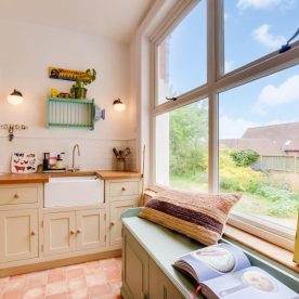 A cozy kitchen bench with an open book—symbolising thoughtful planning in home buying