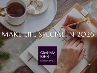 Hands writing in a notebook beside a cup of tea and festive treats, with text overlay “Make Life Special in 2026” and Graham John logo