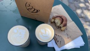 Coffees and pastries on an outdoor table 