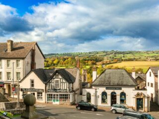 View across the shops and rooftops of Hay-on-Wye towards the surrounding countryside.